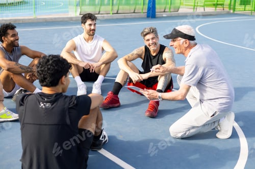 Preview: Coach mentoring diverse men's basketball team outdoors