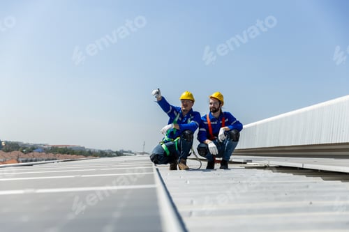 Preview: Man worker set installation and inspection standards of solar panels on roof of an industrial factor