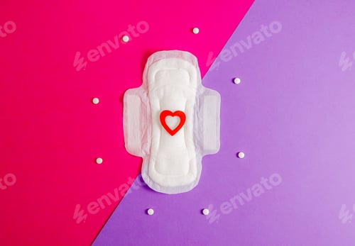 Preview: Women's sanitary pad with a red heart and pills on a bright pink background.
