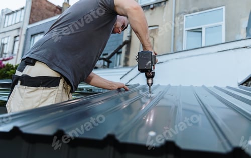 Preview: A waist-up portrait of an experienced roofer installing roofing sheets on a profile shed using a dri