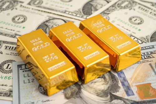 Preview: Gold bar on US dollar and Euro banknote, economy finance exchange trade investment.