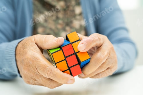 Preview: Bangkok, Thailand August 14, 2023 Alzheimer disease AD, Asian elderly woman patient playing Rubik cu