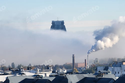Preview: City skyline buildings emerging from dense morning fog