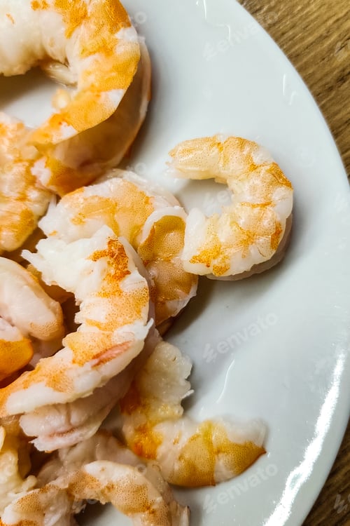 Preview: Boiled peeled shrimp on white plate ready to eat