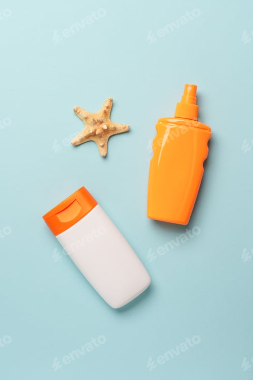 Preview: Sunscreen, sun cream and sunglasses on blue background.