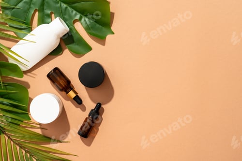 Preview: Natural cosmetic background. Cream jar, serum bottle and tonic on colored background with palm leave