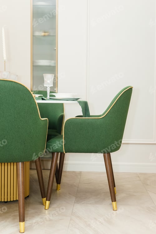 Preview: Modern kitchen interior with green velvet chairs around dining table. Stylish furniture room design.