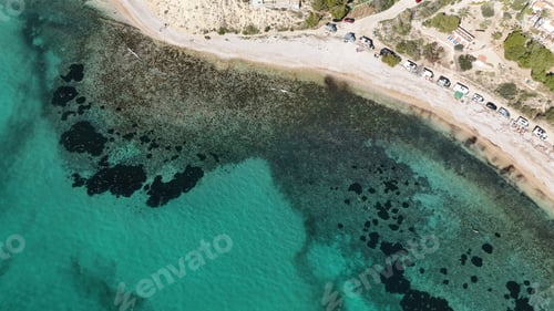 Preview: Drone shot revealing turquoise Mediterranean beach with clear seabed and pebble shore