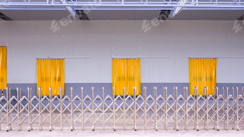 Preview: Industrial warehouse featuring PVC curtains on loading docks and steel expandable gate barrier
