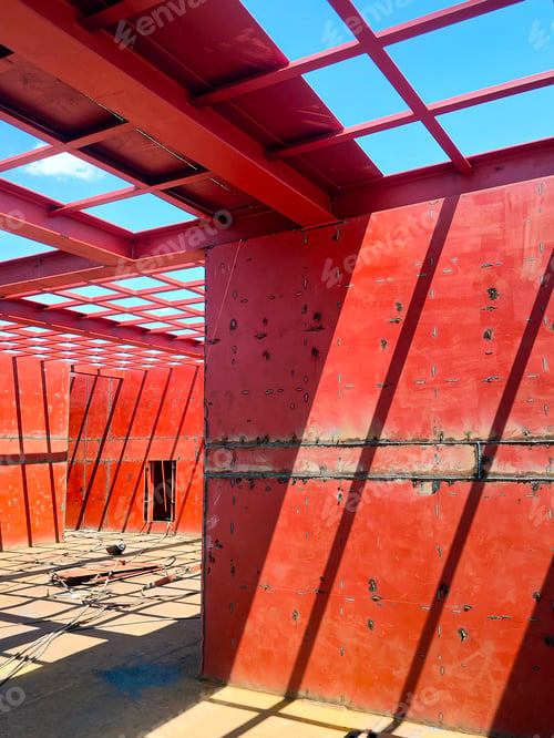 Preview: Steel structure of ship interior with red metal wall and roof beam in shipyard construction site