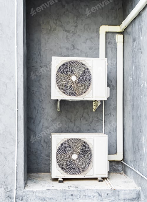 Preview: Air compressor cold temperature on wall grey cement building outdoor construction, electric fan powe