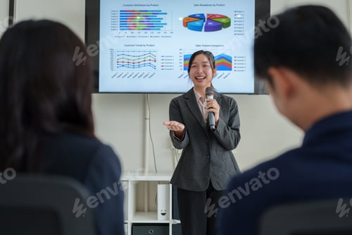Preview: Businesswoman presenting data insights during corporate meeting