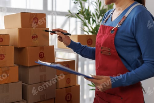 Preview: Person checking shipping boxes for online order fulfillment