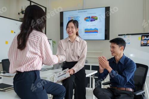 Preview: Business team shaking hands achieving project success