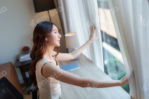 Preview: Woman opening curtains, embracing new day light