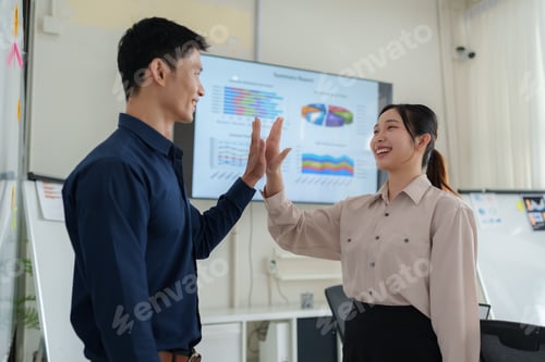 Preview: Business team high fiving celebrating success in office