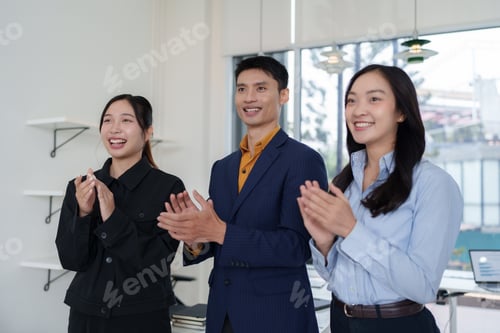 Preview: Business team clapping hands showing appreciation in office