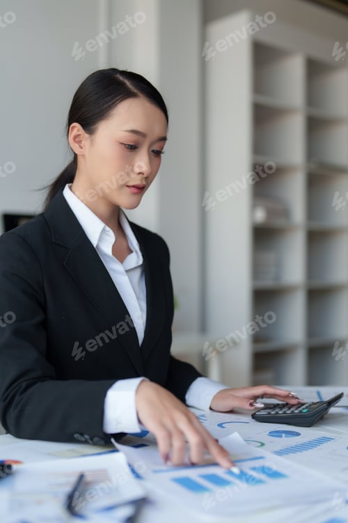Preview: Businesswoman analyzing corporate financial data in office