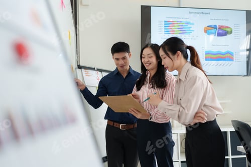 Preview: Asian business team collaborating on project in office meeting