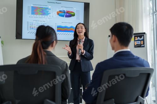 Preview: Businesswoman presenting data report to business team audience