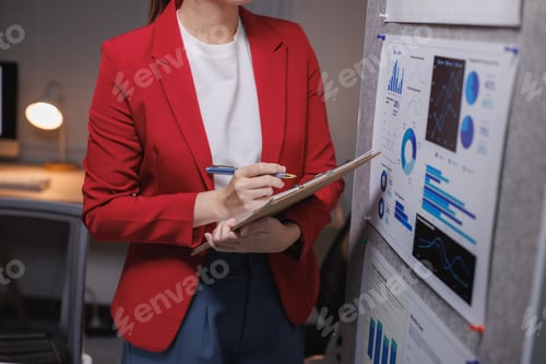 Preview: Professional woman analyzing business data reports on board