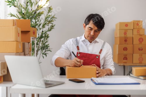 Preview: Man preparing online order package for shipping