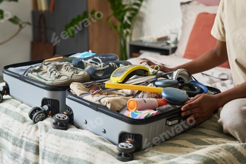 Preview: Adult Woman Packing Suitcase for Vacation Travel Preparation