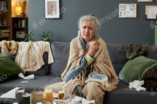 Preview: Portrait of Senior Woman Shivering at Home during Seasonal Illness