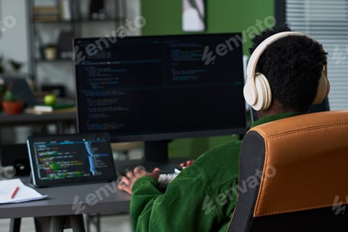 Preview: Black Man Coding at Home Office for Remote Software Development