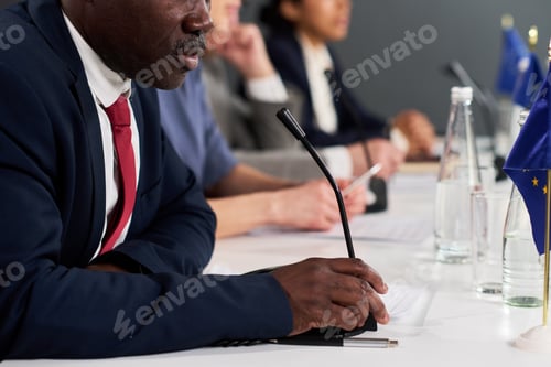 Preview: Black Middle Aged Man Speaking at International Business Meeting