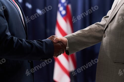 Preview: Black Man and Businessman Shaking Hands in Diplomatic Meeting
