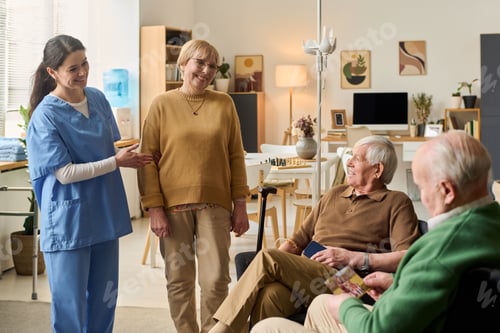 Preview: Senior Woman Visiting Men in Assisted Living with Caregiver Support