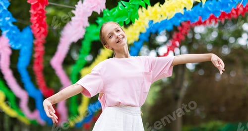 Preview: Child Dancing Under Colorful Party Decorations Outdoors