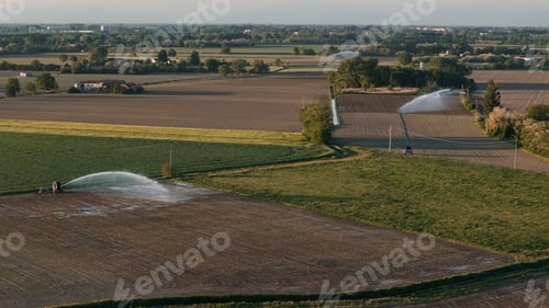 Preview: Agricultural fields in Po Valley with sprinkler irrigation for crop watering, illuminating farming s