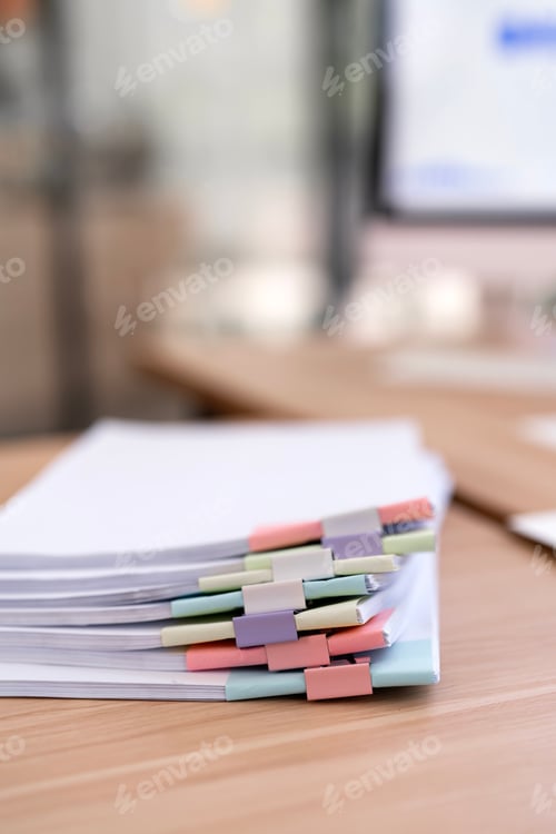 Preview: Stack of Documents with Colorful Paper Clips on Office Desk