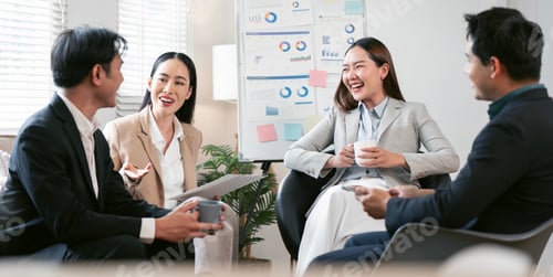 Preview: Happy business colleagues smiling and discussing project success during a strategy meeting in a mode
