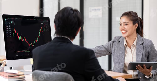Preview: Smiling Asian financial advisor holding tablet and explaining stock market graph to client