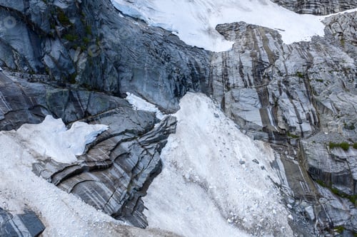 Preview: Glacial Rock Face With Snow And Ice Layers On Mountain Cliff In British Columbia Canada