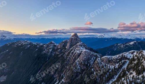 Preview: Snow-Capped Mountain Peak at Sunset Over Rocky Ridges in British Columbia, Canada Coast