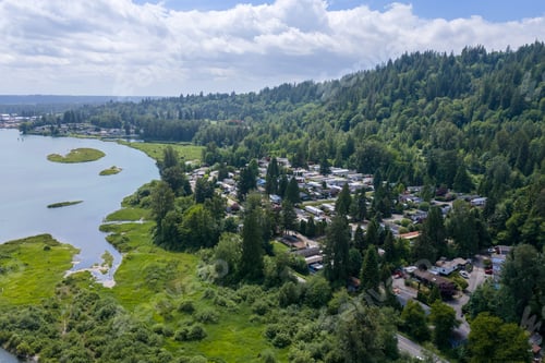 Preview: Aerial View of Riverfront Town Nestled Beside Forested Hills Near Mission, BC, Canada