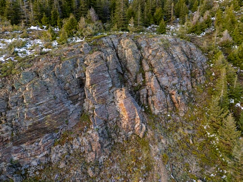 Preview: Rocky Mountain Cliff With Evergreen Forest and Light Snow in British Columbia, Canada