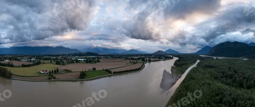 Preview: Panoramic Aerial View of Fraser River Valley Farmland and Mountains Under Dramatic Storm Clouds