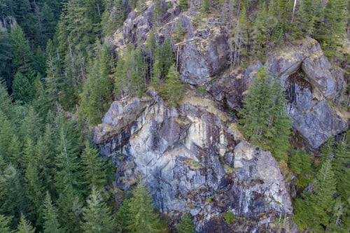 Preview: Rugged Rocky Cliff and Evergreen Forest Aerial Overlook in British Columbia, Canada