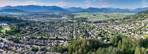 Preview: Aerial View of Promontory Suburban Neighborhood Overlooking Farmland and Mountains in Chilliwack Bri