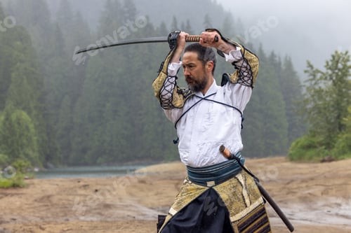 Preview: Samurai With Katana Sword Practicing Traditional Martial Stance at Stave Lake in Mission, British Co