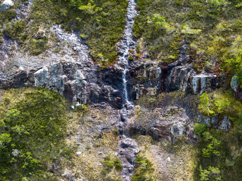 Preview: Mossy Rocky Cliff With Thin Waterfall and Alpine Stream on a British Columbia Mountain