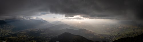 Preview: Dramatic Storm Clouds Over Sunlit Mountain Valley and Farmland in British Columbia, Canada
