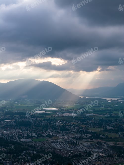 Preview: Dramatic Sun Rays Breaking Through Storm Clouds Over Chilliwack Valley, British Columbia, Canada