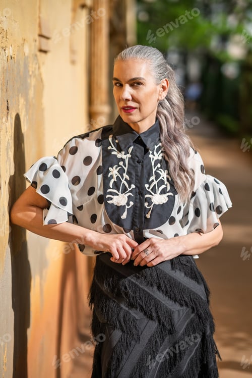 Preview: Elegant woman smiling. Stylish lady looks confidently. Graceful woman stands calmly outdoors