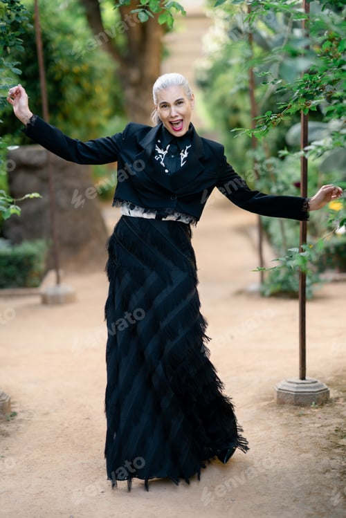Preview: Woman moves happily in garden. Woman gleefully twirls in bright garden with radiant smile